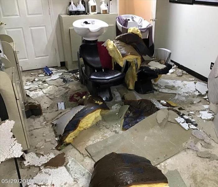 Water damage, ceiling tiles fallen, insulation on floor