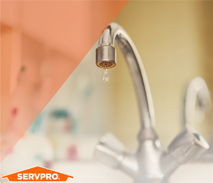 Sink dropping water with orange triangle and SERVPRO logo